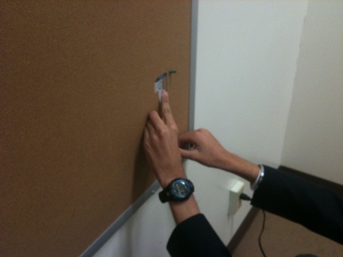 Student measuring on a wall