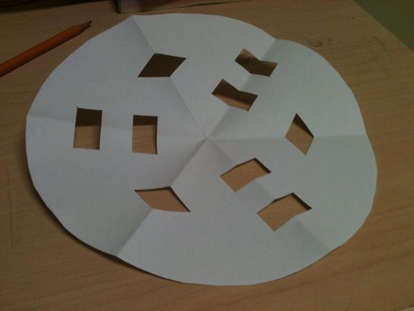 Paper folded into sixths, with cut-outs