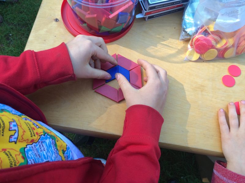 A child playing with pattern blocks